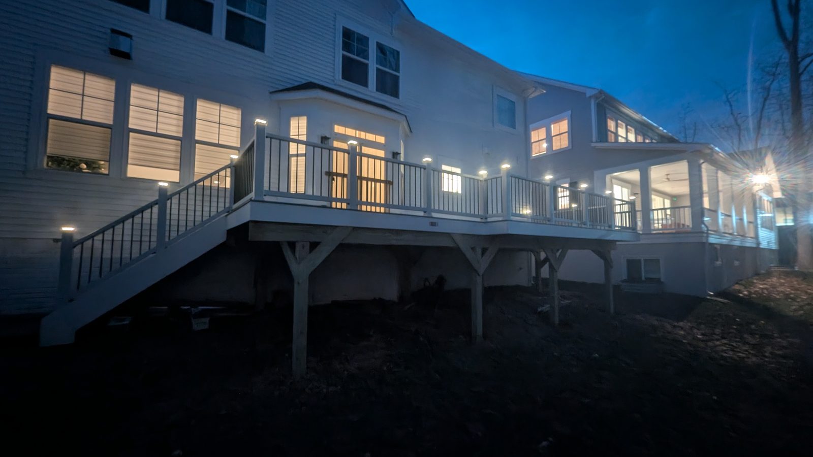 Elevated composite deck with railing lights at dusk, built by NWP in Northern Virginia